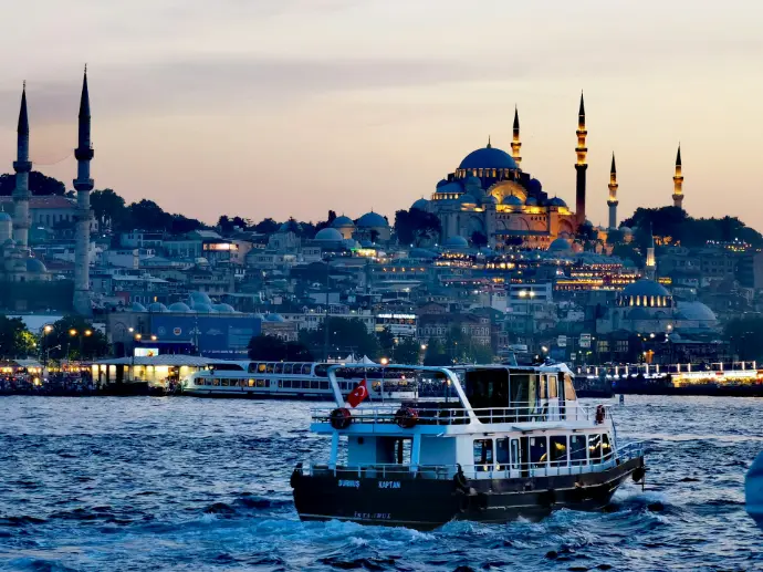 A passenger boat on the Bosphorus with the Suleymaniye Mosque in Istanbul